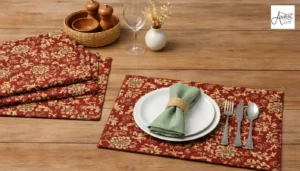 A complete dining set featuring red floral placemats and matching linens produced by professional table runner manufacturers.