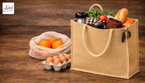 A heavy-duty jute shopping bag filled with groceries on a wooden background, showcasing the craftsmanship of handmade tote bag manufacturers.