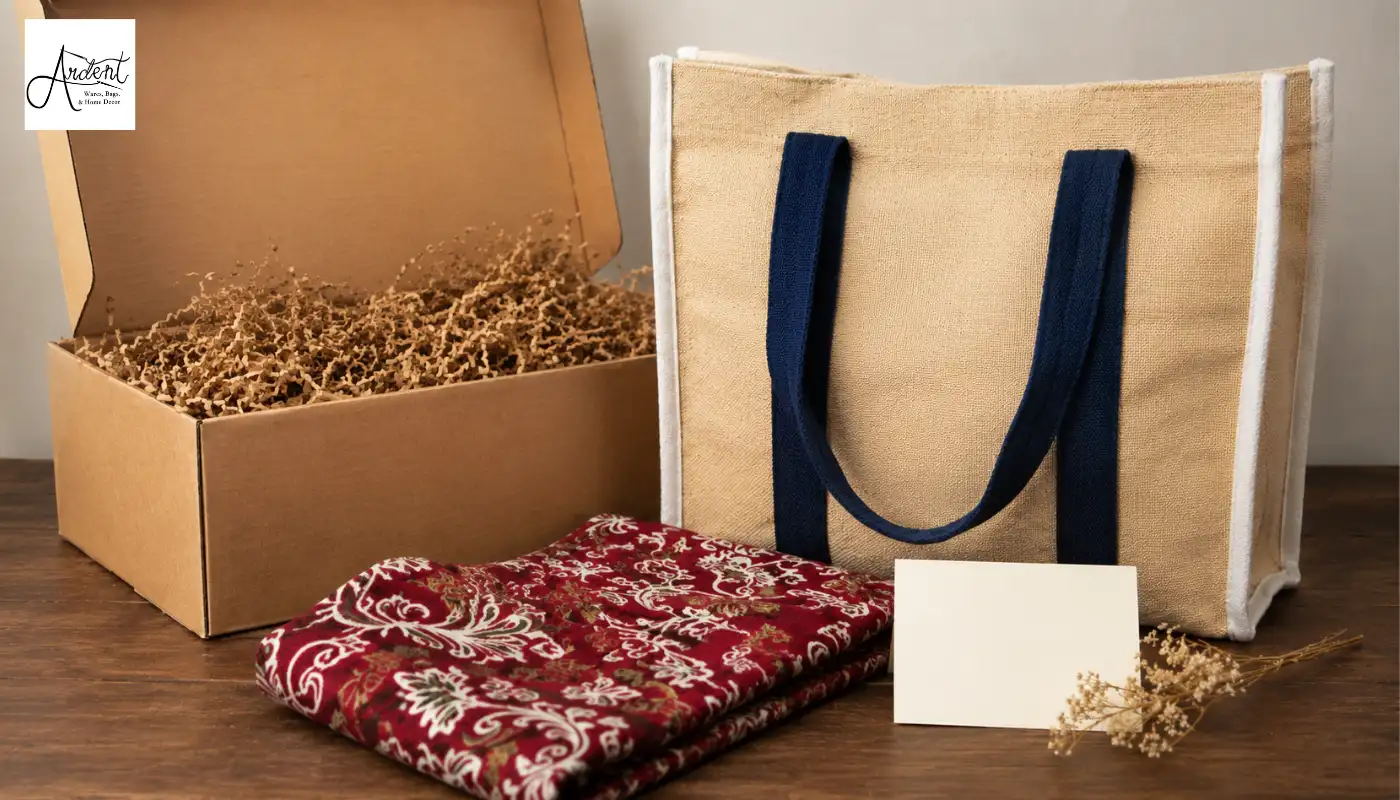 Premium wine gift bag packaging kit featuring a jute bag with blue handles alongside a cardboard hamper box and red fabric.